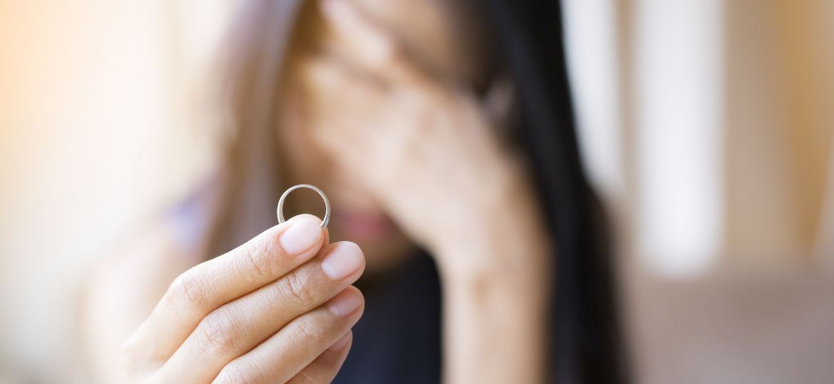 close-up-sad-woman-holding-ring-home