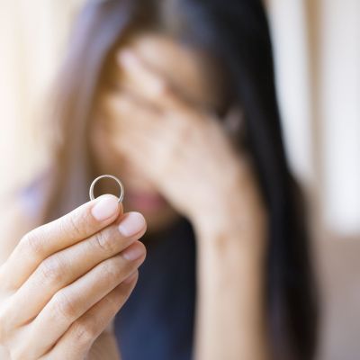 close-up-sad-woman-holding-ring-home