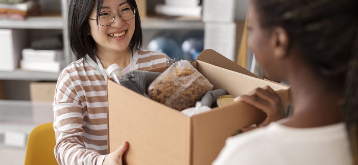 volunteer-handing-donation-box