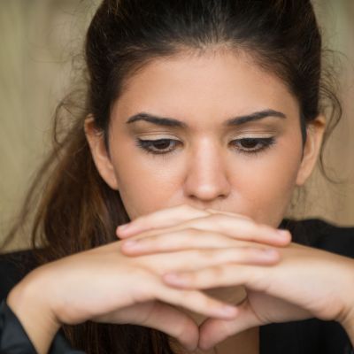 Close-up of young businesswoman in deep thought
