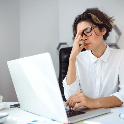 Young beautiful businesswoman working with laptop at workplace in office.
