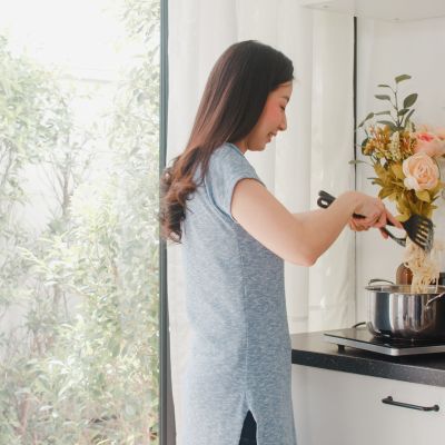 Young Asian Japanese lady enjoy cooking at home. Lifestyle women