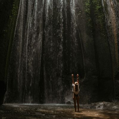 young-woman-waterfall-rock-bali-indonesia